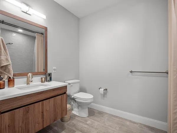 a bathroom with a double vanity sink toilet and a mirror