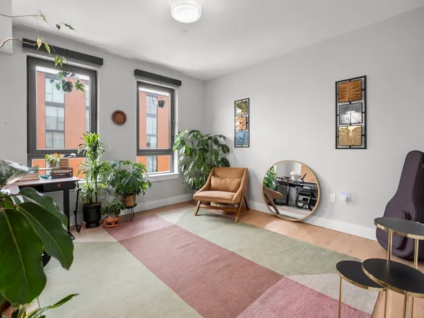 a living room with furniture and a potted plant