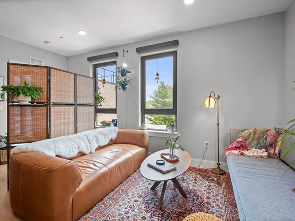 a living room with furniture and a large window