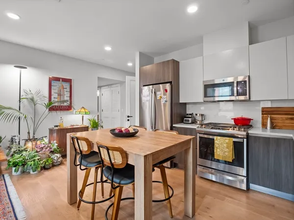 a kitchen that has a table and chairs in it