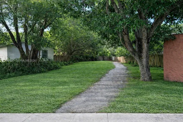 a view of a backyard with large trees