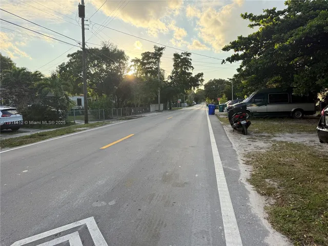 a view of a road with a car parked on the road