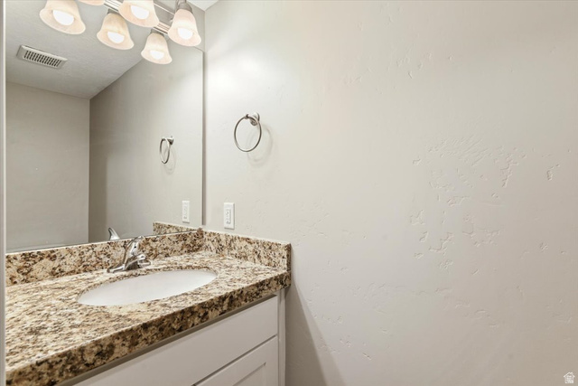 857 225 South Springville, UT 84663 - Photo 8 of 23 Bathroom vanity with a granite countertop, undermount sink, and chrome faucet
