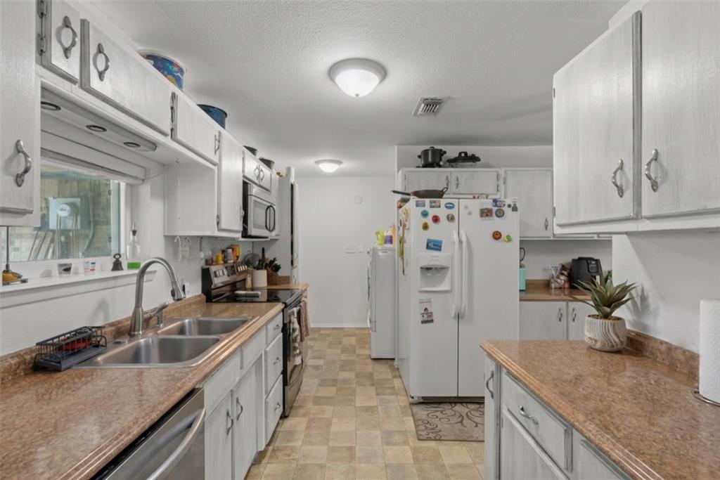 1205 South Rusk Street Weatherford, TX 76086 - Photo 11 of 27 Galley Kitchen w/Dishwasher