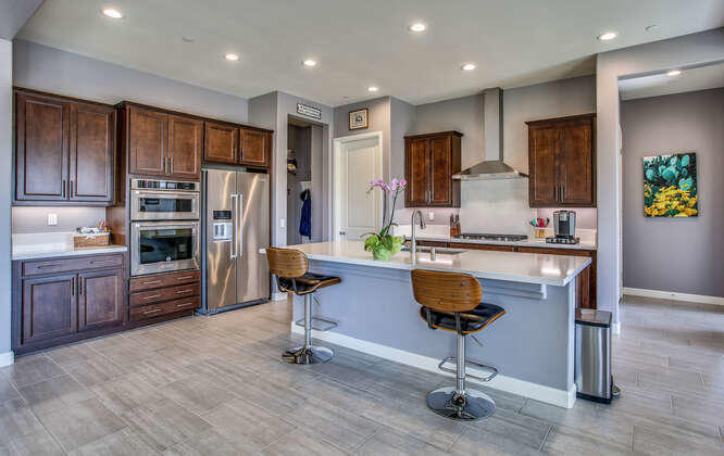 21 Riesling Rancho Mirage, CA 92270 - Photo 15 of 53 a kitchen with stainless steel appliances granite countertop a refrigerator and a stove top oven