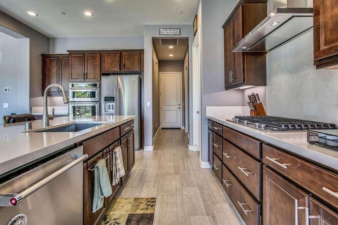 21 Riesling Rancho Mirage, CA 92270 - Photo 16 of 53 a kitchen with stainless steel appliances granite countertop a stove a sink dishwasher and a refrigerator