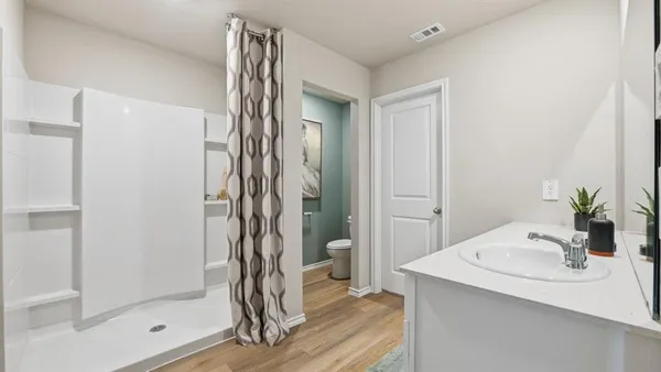 a bedroom with a bed and a mirror