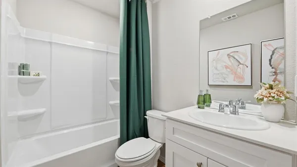 a bedroom with a bed and a dresser in it