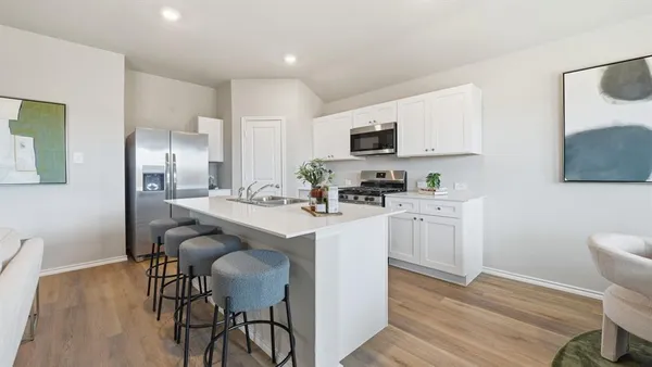 a front view of a house with a garden and yard