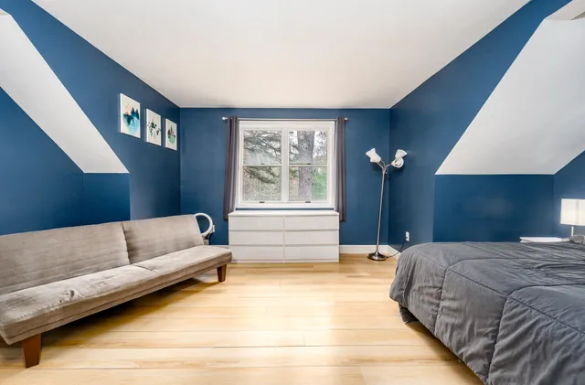 a living room with a bed furniture and a window