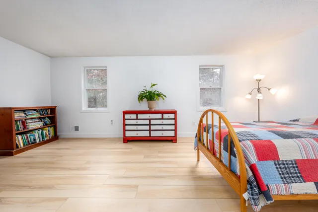 a bed room with a bed and a book shelf
