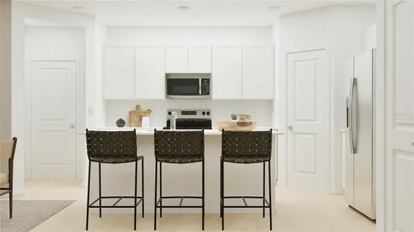 a living room with furniture a flat screen tv and kitchen view