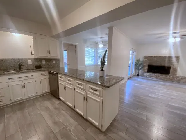 a kitchen with stainless steel appliances granite countertop a stove and a sink