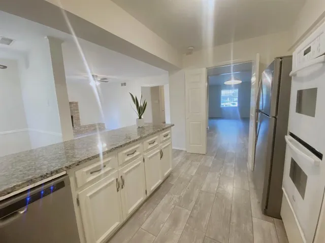 a spacious bathroom with a granite countertop double vanity sink and a mirror