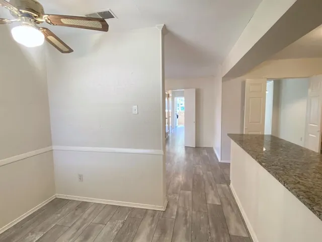 a view of hallway with wooden floor