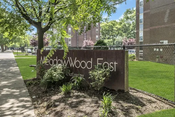 a sign that is sitting on a wooden fence