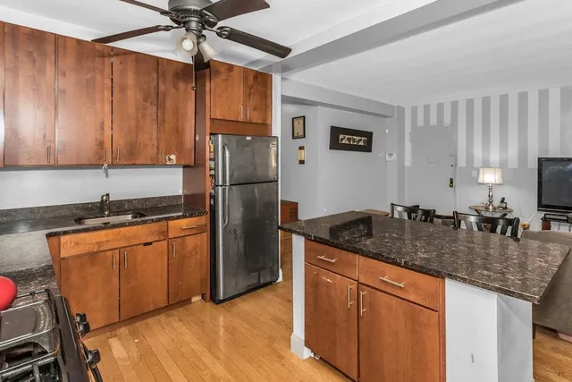 a kitchen with stainless steel appliances granite countertop a sink refrigerator and microwave