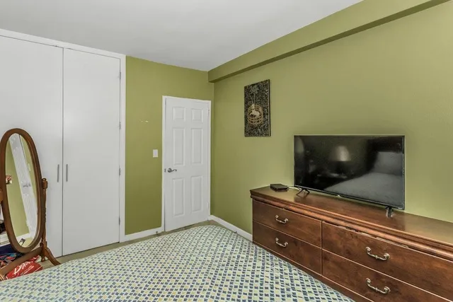 a room with a flat screen tv and washer