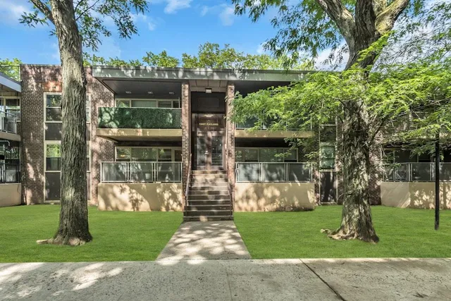 a front view of house with a garden