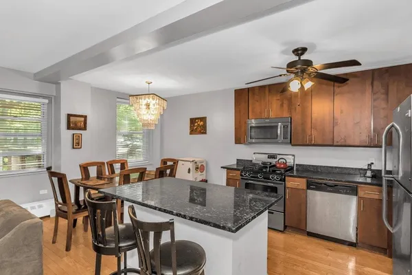 a kitchen with a table chairs stove and cabinets