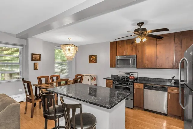 a kitchen with a table chairs stove and cabinets