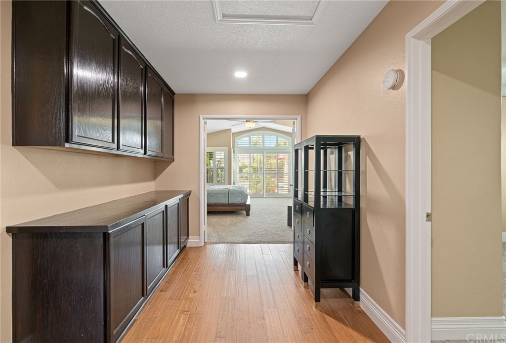 1879 Apostle Lane Riverside, CA 92506 - Photo 19 of 49 a kitchen with a fridge and wooden floor