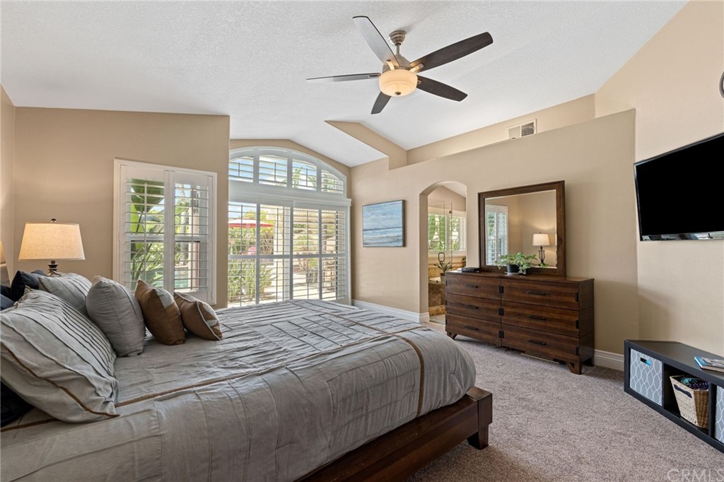 1879 Apostle Lane Riverside, CA 92506 - Photo 21 of 49 a bedroom with a bed a window and a television