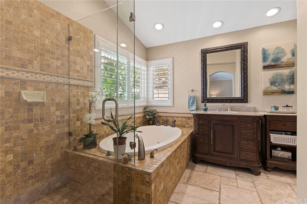 1879 Apostle Lane Riverside, CA 92506 - Photo 22 of 49 a bathroom with a sink a bathtub and a mirror