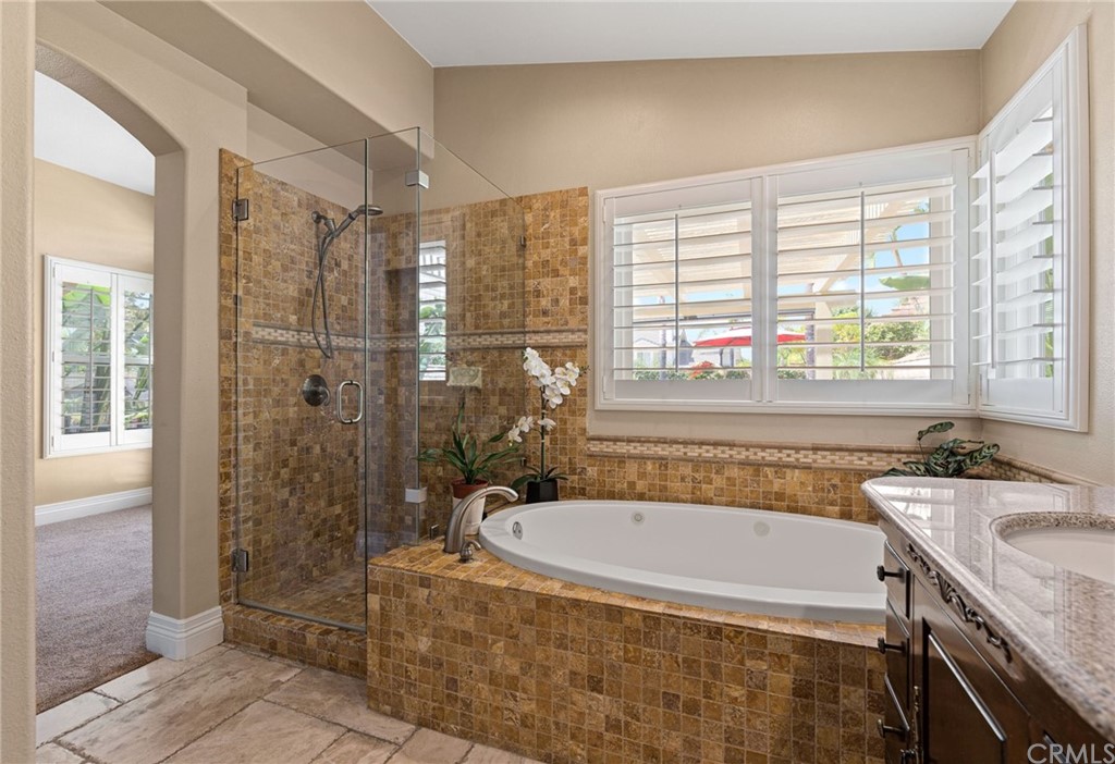 1879 Apostle Lane Riverside, CA 92506 - Photo 24 of 49 a bathroom with a granite countertop bathtub shower and sink