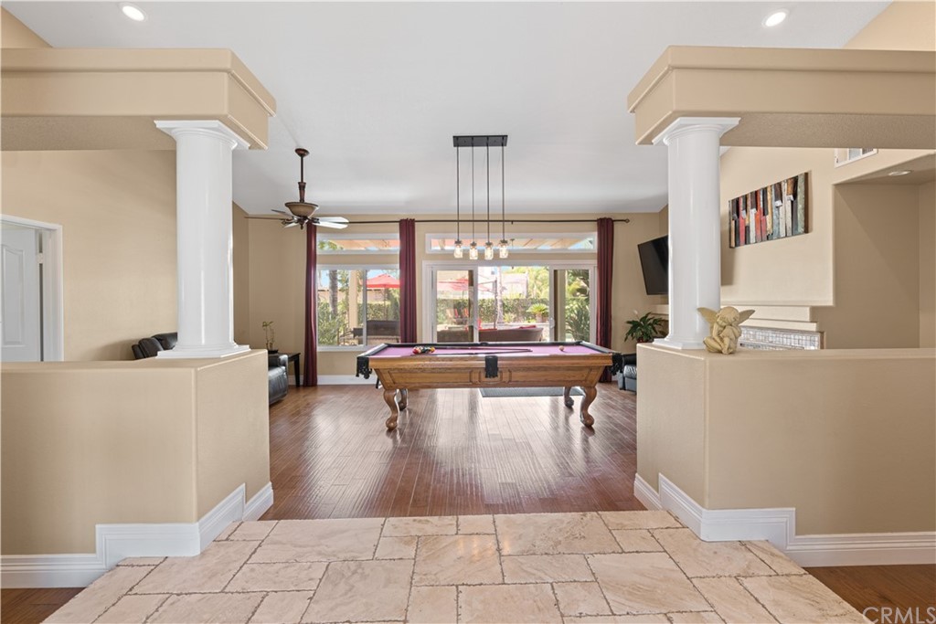 1879 Apostle Lane Riverside, CA 92506 - Photo 8 of 49 a living room with couches a dining table and chairs with kitchen view