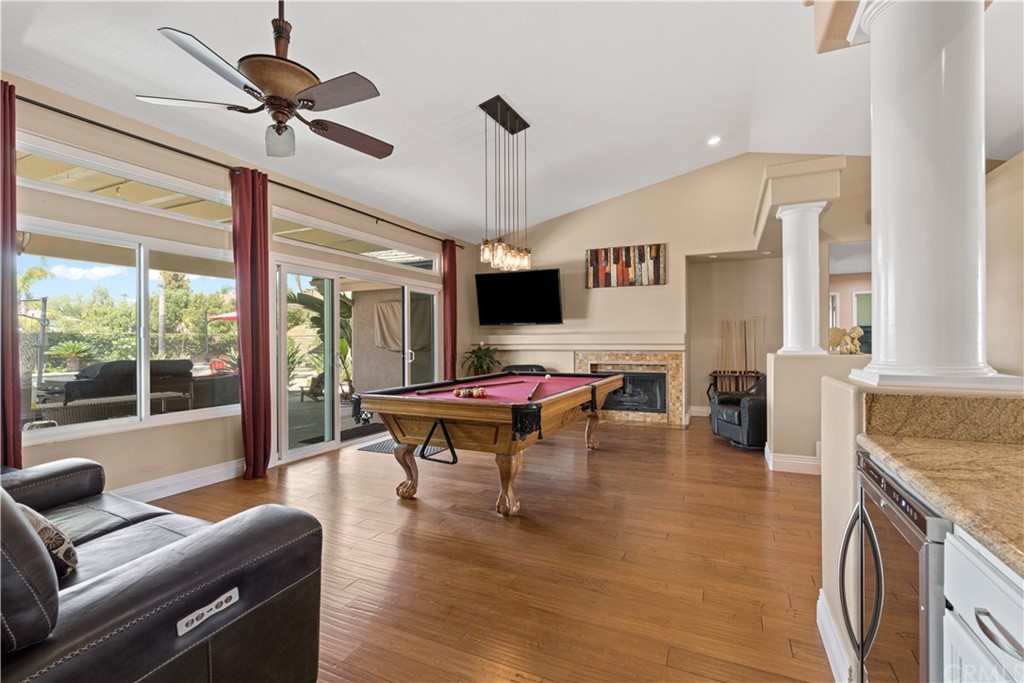 1879 Apostle Lane Riverside, CA 92506 - Photo 9 of 49 a living room with furniture a fireplace and a floor to ceiling window