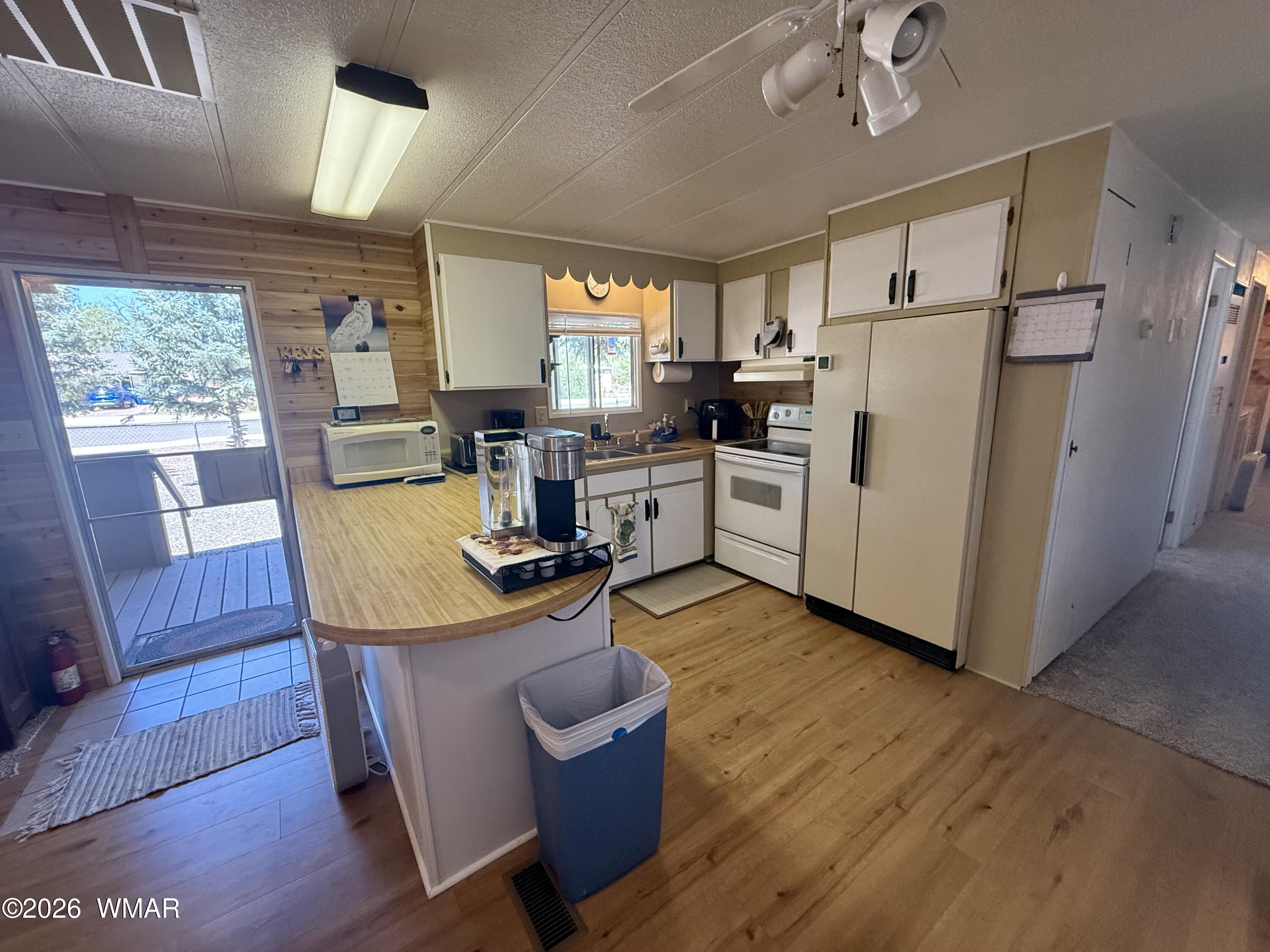 727 South Butler Street Eagar, AZ 85925 - Photo 5 of 32 a view of kitchen with refrigerator stove dining table and chairs