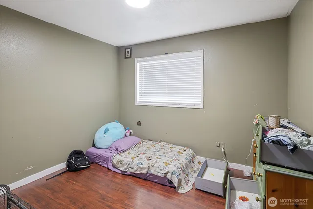 a bedroom with bed and a window