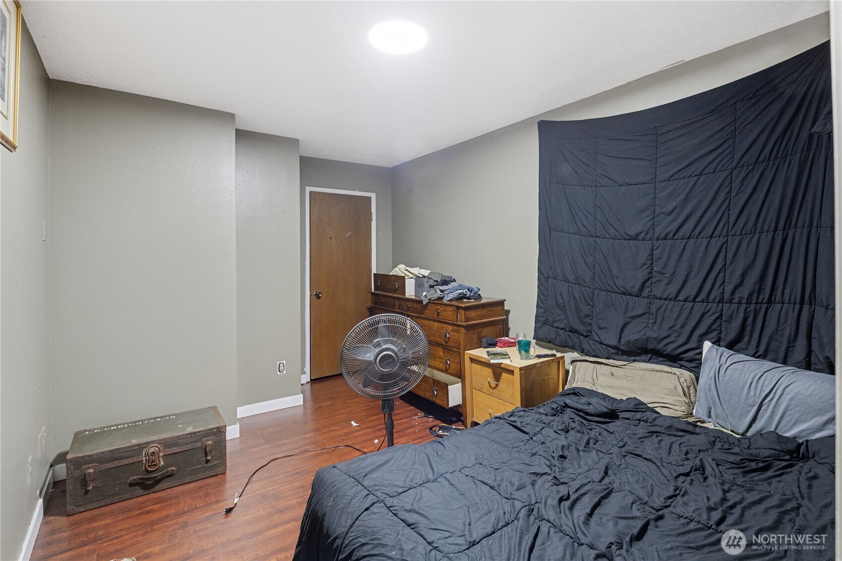 7025 Hannegan Road Lynden, WA 98264 - Photo 15 of 27 a bedroom with a bed and wooden floor