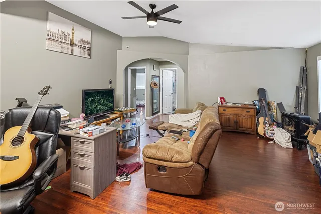 a living room with furniture and a wooden floor