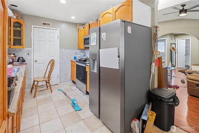 a kitchen with stainless steel appliances granite countertop a stove microwave and sink