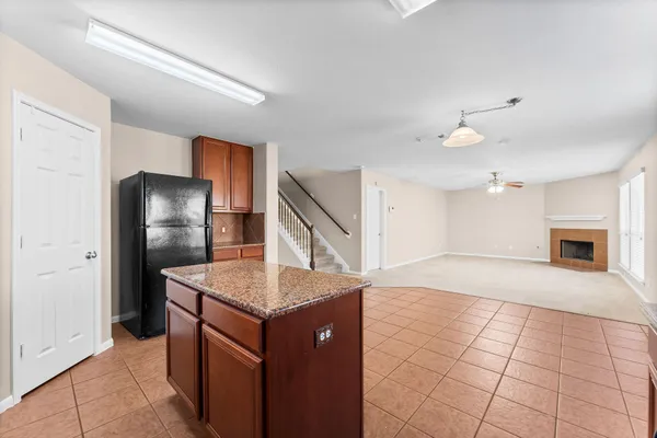 a kitchen with stainless steel appliances granite countertop a sink and a refrigerator