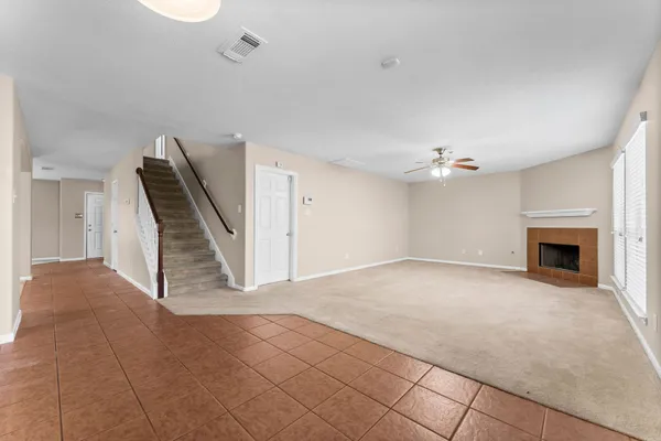 a view of an empty room with a fireplace