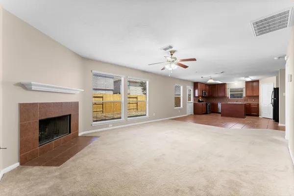 a view of a livingroom with a fireplace and cabinet