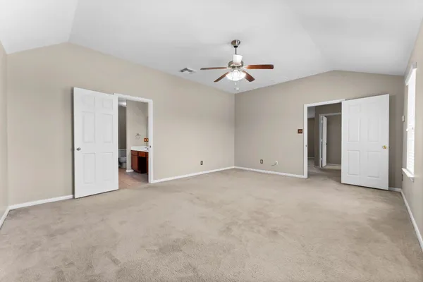 a view of an empty room with a ceiling fan