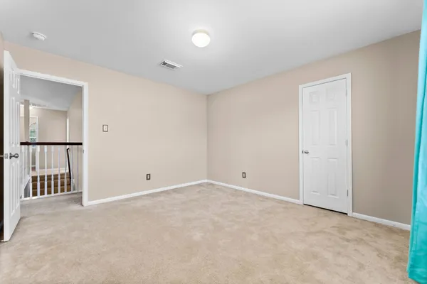 a view of an empty room with a closet