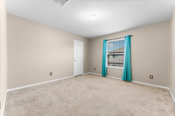 an empty room with windows and mirror