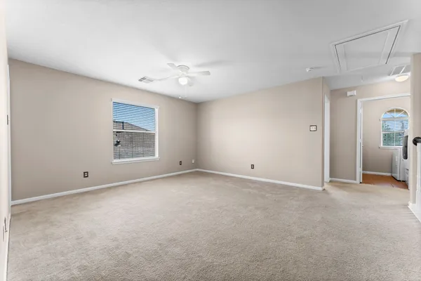 a view of an empty room with a window