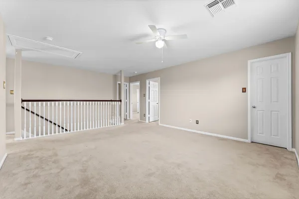 a view of a livingroom with a ceiling fan and window