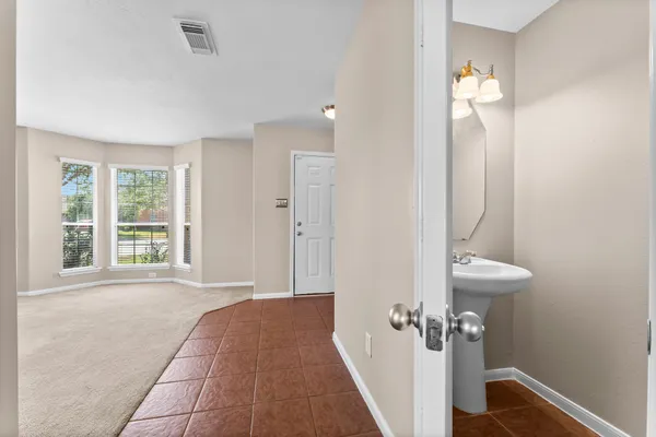 a view of a bathroom with a sink and mirror
