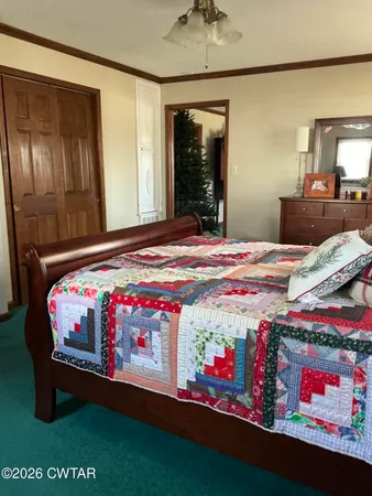 a bedroom with bed and window