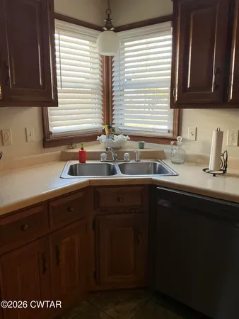 a kitchen with a sink cabinets and window