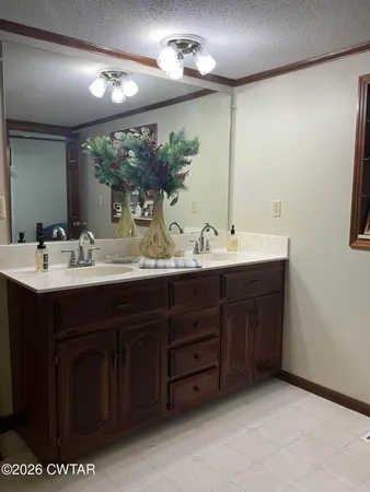 a bathroom with a sink double vanity and a mirror