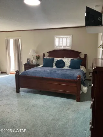 a bedroom with a bed and window