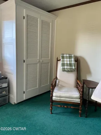 a view of a bedroom with furniture and window